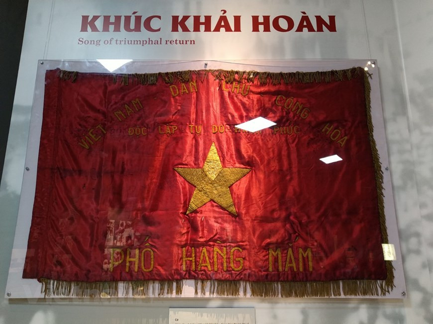 A national flag embroidered by residents of Hanoi capital city’s Hang Mam street in the Old Quarter is on display. It was waved to welcome soldiers who marched in Hanoi to liberate the city on October 10, 1954. The morning of that day saw thousands of the Hanoi residents flood the streets with flags and flowers to welcome home Vietnamese soldiers. The national flag of Vietnam was designed in 1940 and was modified on November 30, 1955 to make the rays of the star pointier. The red background symbolises revolution and bloodshed. The yellow star represents the five main classes in Vietnamese society - workers, farmers, soldiers, intellectuals, and entrepreneurs. (Photo: VietnamPlus)