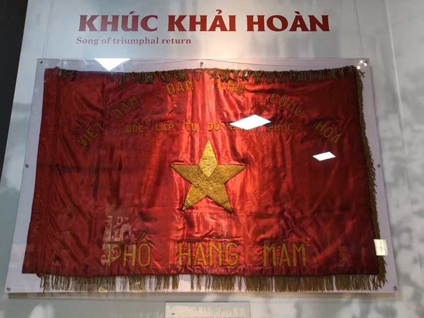 A national flag embroidered by residents of Hanoi capital city’s Hang Mam street in the Old Quarter is on display. It was waved to welcome soldiers who marched in Hanoi to liberate the city on October 10, 1954. The morning of that day saw thousands of the Hanoi residents flood the streets with flags and flowers to welcome home Vietnamese soldiers. The national flag of Vietnam was designed in 1940 and was modified on November 30, 1955 to make the rays of the star pointier. The red background symbolises revolution and bloodshed. The yellow star represents the five main classes in Vietnamese society - workers, farmers, soldiers, intellectuals, and entrepreneurs. (Photo: VietnamPlus)
