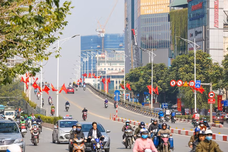 Streets are filled with red colours of flags (Photo: Minh Son/Vietnamplus)