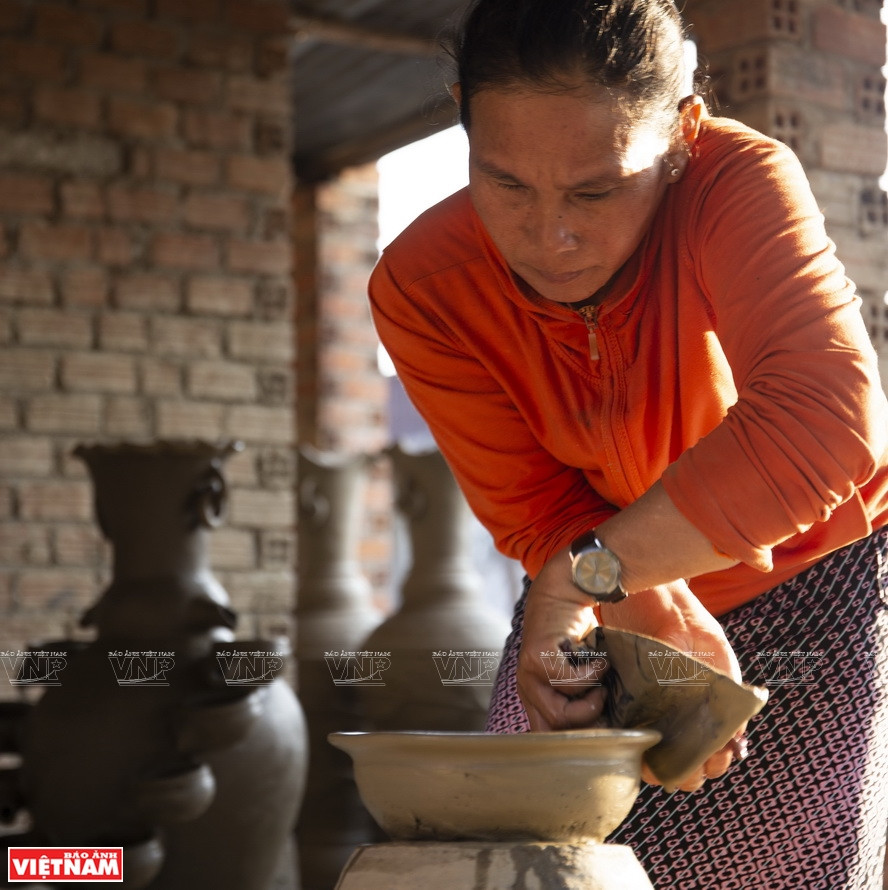 Artisan Dang Thi Trang, 48, shapes a pottery product (Photo: VNA)