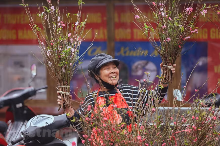 Most of the sellers are from famous flower villages such as Ngoc Ha, Tu Lien, Nghi Tam, Nhat Tan and Quang Ba, among others. Actually, along Hang Luoc Street, there stands a typical red and yellow color of traditional Tet fulfilled and it’s also the ideal place for the young to check-in and find some souvenirs. Although it’s too crowded, the florist area is the most bustling place because cherry blossoms are the indispensable part of Tet in the North. Hang Luoc flower market not only satisfies our sight but also feed our taste by eye-catching sweeties, dried fruits, jams, and many savory street foods. (Photo: Vietnamplus) 