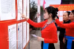 Voters from the Muong ethnic minority group carefully study candidates' profiles before casting their ballots. (Photo: VNA)