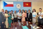 Nguyen Quyet Tien (sixth from left), an engineer and translator, donates a set of Vietnamese-Czech-English dictionaries to the Vietnamese language centre. (Photo: VNA)