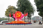 The emblem, Party flag and national flag are prominently displayed at the Dien Bien Phu – Doc Lap – Chu Van An intersection in Hanoi to welcome the 14th National Congress of the Communist Party of Vietnam. (Photo: VNA)
