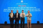VITA Chairman Vu The Binh presents certificates of merit and insignias to units and individuals for contributions to tourism industry (Photo: VNA)
