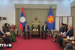 A delegation from the Vietnamese Embassy in China visits the Lao Embassy on December 1 to convey congratulations on the 50th National Day of Laos. (Photo: VNA)