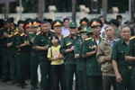 Veterans offer incense in memory of their fallen comrades at Duc Co Martyrs’ Cemetery. (Photo: VNA)