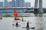 Stand-up paddleboarding (SUP) attracts many young participants at the 2024 Ho Chi Minh City Open River Swimming Championship and the first HCM City Open Stand-up Paddleboarding Championship. (Photo: VNA)