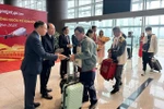 Representatives from Quang Ninh's Van Don district and Tourism Department welcome and give lucky money to visitors at Van Don airport. (Photo: VNA)