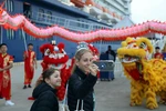 Tourists from Celebrity Solstice, the first cruise ship to arrive in Quang Ninh in 2026, enjoy taking photos with a Vietnamese lion and dragon dance troupe. (Photo: VNA)