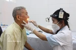 An elderly receives health check-ups. (Photo: VNA)