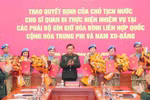 Deputy Minister of National Defence Sen. Lieut. Gen. Hoang Xuan Chien (C) hands over the State President's decisions to the officers. (Photo: VNA)