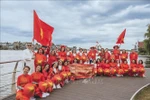 Participants in the ao dai walk in the Netherlands on August 31 to mark the 80th anniversary of Vietnam’s National Day. (Photo: VNA)