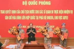 Senior Lieutenant General Phung Si Tan (second from left), Deputy Chief of the General Staff, presents decisions of the State President and the Minister of National Defence to three officers who are about to depart for duties at the UN peacekeeping mission in Abyei. (Photo: VNA)
