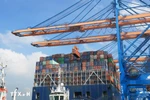 Unloading containers onto ships at Gemalink International Port (Photo: VNA)