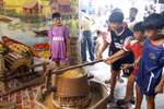 Children enjoy exploring a traditional farming space at the event. (Photo: VNA)