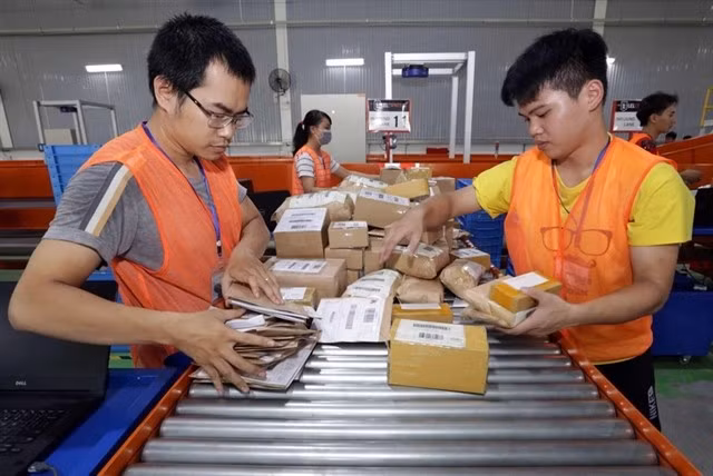 Workers sorting out packages at a delivery company in HCM City. (Photo: VNA)