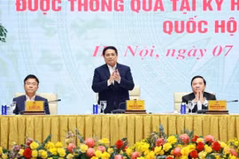 Prime Minister Pham Minh Chinh (C) chairs a conference on March 7 on the implementation of laws and resolutions adopted at the 9th extraordinary session of the 15th National Assembly. (Photo: VNA)