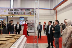 Visitors to a booth at BIFA WOOD Vietnam 2025 (Photo: VNA)