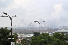 Smoke rises from an oil well in Haifa city, northern Israel, after being hit by a missile launched from Iran on March 19, 2026. (Photo: Xinhua/VNA)