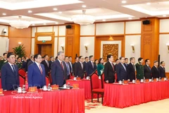 Party General Secretary To Lam and officials perform the flag-salute ceremony at the event held on April 3. (Photo: VNA)