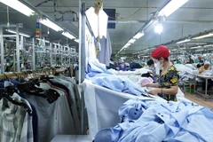 Workers produce apparel for export. (Photo: VNA)