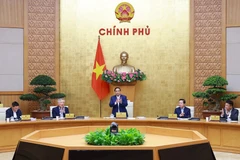 PM Pham Minh Chinh chairs the Government’s regular meeting on December 6. (Photo: VNA)