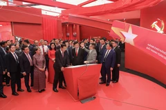 Deputy Prime Minister Mai Van Chinh, Party General Secretary and President of Laos Thongloun Sisoulith, and President of the Cambodian People’s Party and President of the Cambodian Senate Hun Sen visit a space of the Nhan Dan (People) newspaper at the exhibition on September 2. (Photo: VNA) 