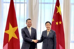 Vietnamese Ambassador to China Pham Thanh Binh (left) pays a courtesy call to Chinese Minister of Justice He Rong on March 19. (Source: VNA)