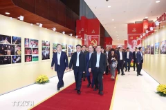 Permanent member of the Party Central Committee’s Secretariat Tran Cam Tu (front, centre) and other officials examine an exhibition of publications serving the 14th National Party Congress on January 13. (Photo: VNA)