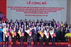Party General Secretary To Lam (front, fifth from left) presents the resolutions and decisions on the merger of administrative units, the establishment of Party organisations, and the appointment of personnel at the ceremony in HCM City on June 30. (Photo: VNA)