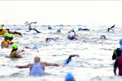 Athletes participate in swimming event at IRONMAN 70.3 Da Nang 2025 (Photo: VNA)