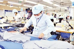 Workers at Garment 10 Corporation produce apparel for export. (Photo: Nhan Dan) 