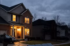 Portable solar panels charge a power station outside a suburban home at dusk (Photo: solarquarter.com)