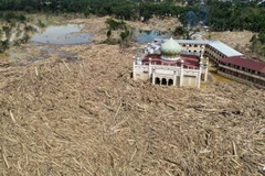 An aerial view shows vast remains of uprooted trees at the Darul Mukhlisin Islamic boarding school and mosque in the aftermath of flash floods at Aceh Tamiang in Northern Sumatra on Dec 10, 2025. (Photo: AFP)