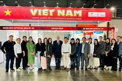Officials and representatives of businesses at the Vietnamese pavilion at ICMA Milan 2025 (Photo: VNA)