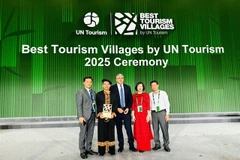 Representatives of Tuyen Quang province and organising committee pose for photo after Lô Lô Chải is honoured one of best tourism villages in 2025. — (Photos courtesy of Tuyen Quang province) 