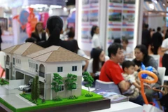 A miniature housing model is displayed at a house and condo fair held at the Queen Sirikit National Convention Center in Bangkok. (Photo: bangkokpost.com)