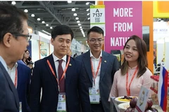 Vietnamese Ambasador to Russia Dang Minh Khoi (first, left) visits a Vietnamese booth at the 34th WorldFood Moscow. (Photo: VNA)
