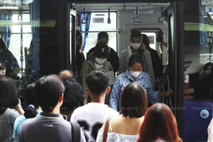 Some commuters wear face masks to protect their health as they get off a bus at Victory Monument in Bangkok last month. (Photo: bangkokpost.com)