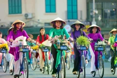 Women participate in the “Ao dai connecting Hanoi tourism and heritage” programme in 2023. (Photo: VNA) 