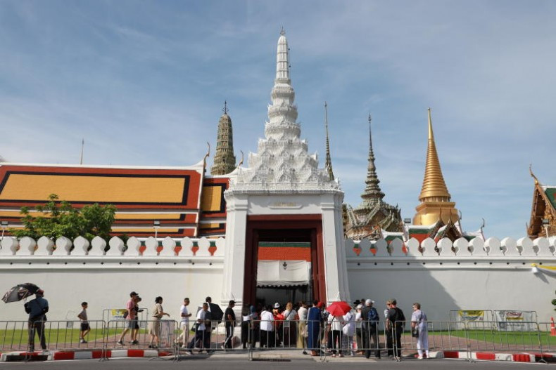 Tourists wait outside a gate at the Grand Palace in Bangkok in June 2025. (Photo: Bangkok Post)