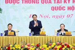 Prime Minister Pham Minh Chinh (C) chairs a conference on March 7 on the implementation of laws and resolutions adopted at the 9th extraordinary session of the 15th National Assembly. (Photo: VNA)