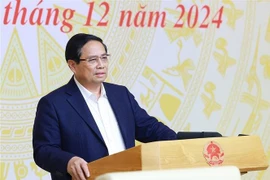 Prime Minister Pham Minh Chinh speaks at the national conference in Hanoi on December 25 on the implementation of the laws and resolutions passed by the 15th National Assembly (NA) at its eighth session. (Photo: VNA)