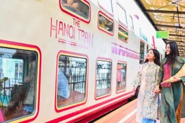 Tourists ride the “Five Gates” train, a new tourism product in Hanoi. (Photo: nhandan.vn)
