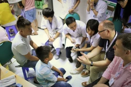Doctors from the UK charity Facing The World (FTW) conduct screenings for pediatric patients at Viet Duc University Hospital during their 2018 mission. (Photo courtesy of FTW)