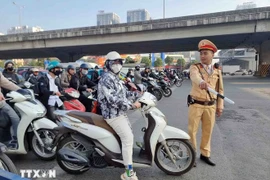 Many motorists now adhere to regulations voluntarily. (Photo: VNA)