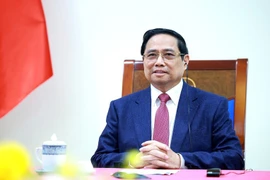 Vietnamese Prime Minister Pham Minh Chinh at the phone talks with his Singaporean counterpart Lawrence Wong on December 18. (Photo: VNA)