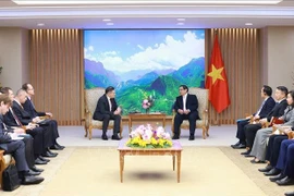 Prime Minister Pham Minh Chinh (right) receives Rosatom Director General Alexey Likhachev in Hanoi on January 13. (Photo: VNA)