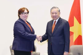 General Secretary of the Communist Party of Vietnam (CPV) Central Committee To Lam (right) meets with Tiina Sandberg, Chairperson of the Communist Party of Finland (SKP), in Helsinki on October 22 (local time). (Photo: VNA)